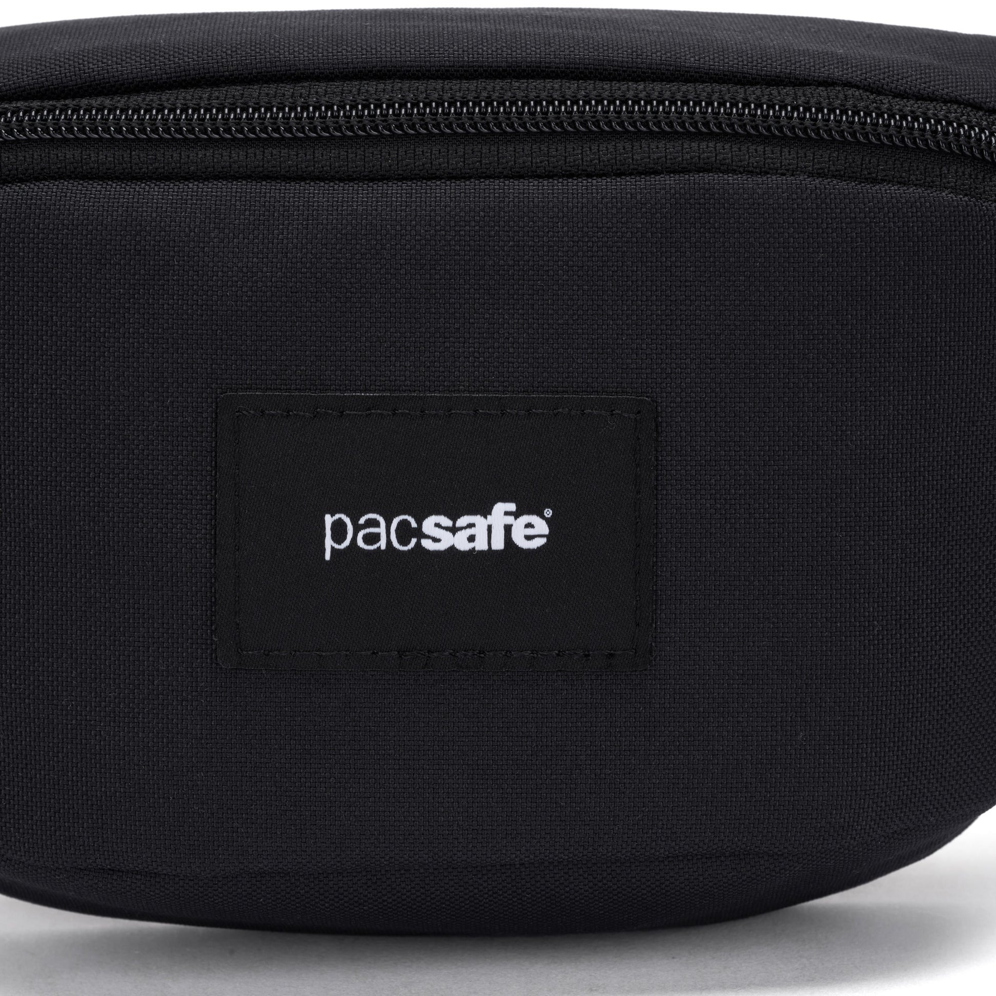 Close-up of the Pacsafe® GO Anti-Theft Micro Sling, black, with a visible Pacsafe logo on the front.