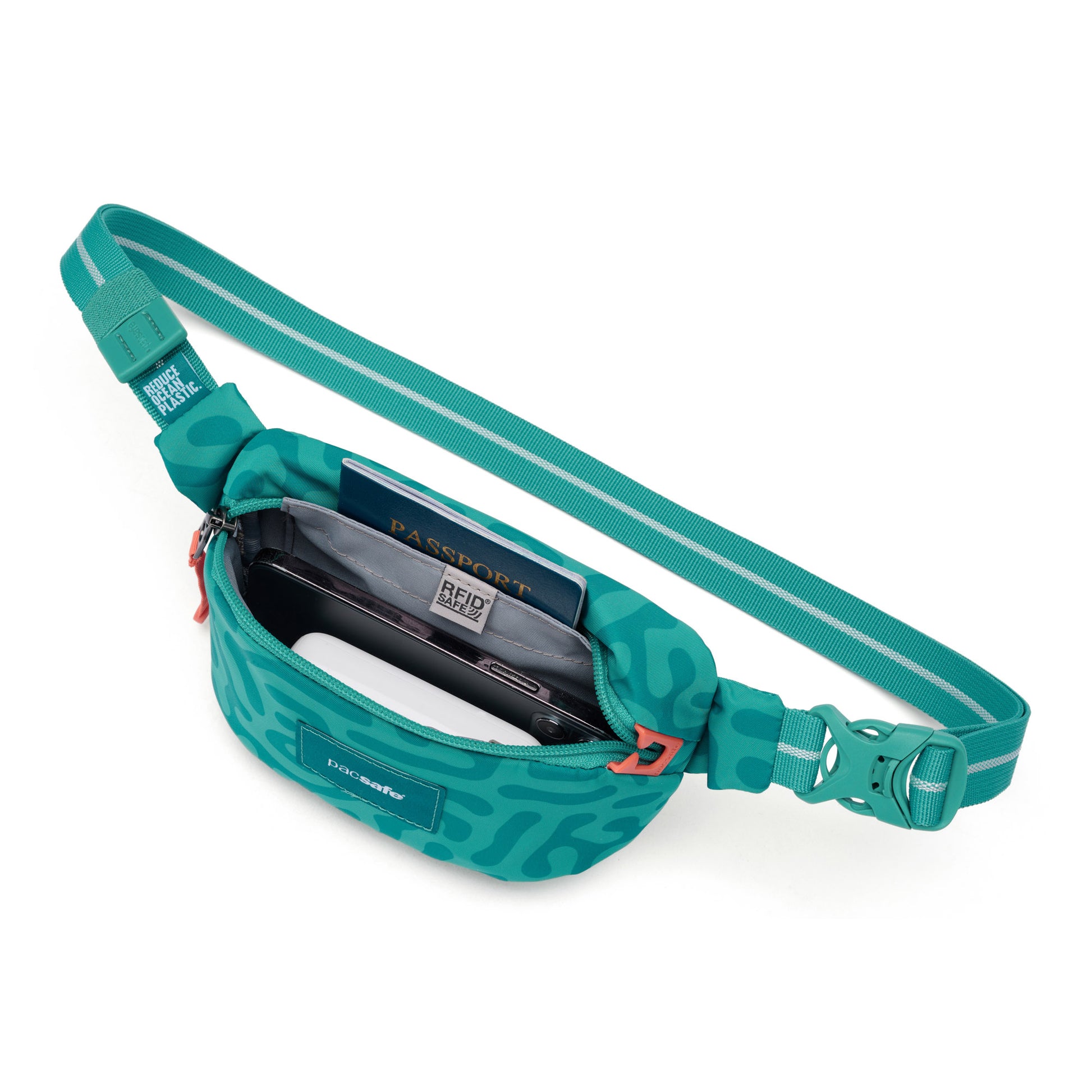 The Pacsafe® GO Anti-Theft Micro Sling by Pacsafe in teal fits a passport and phone in its open main compartment.