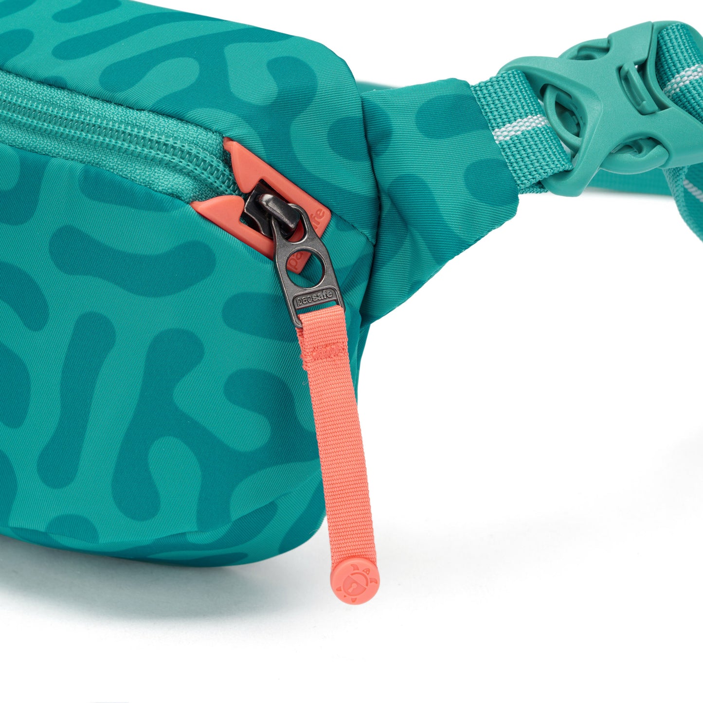 Close-up of the Pacsafe® GO Anti-Theft Micro Sling in teal and coral, made from recycled polyester.