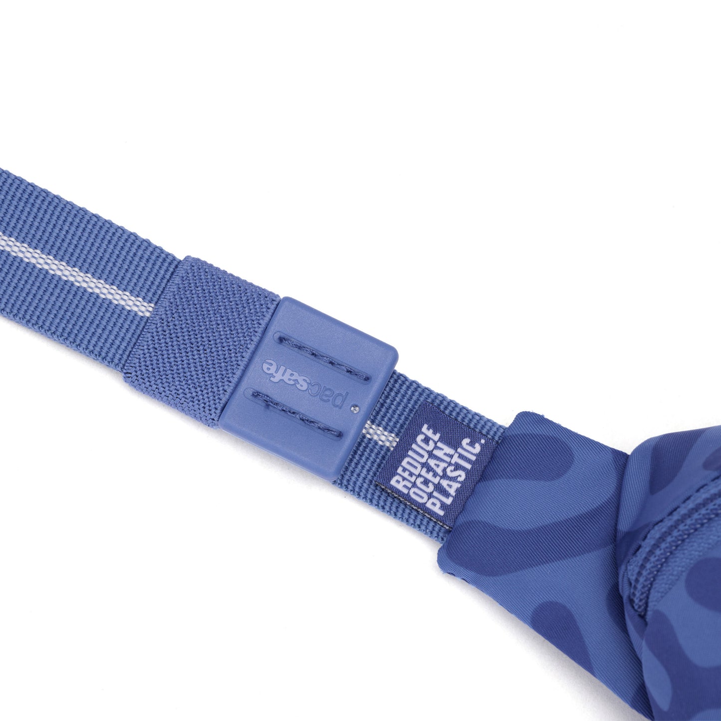 Close-up of Pacsafe GO Anti-Theft Micro Sling’s blue recycled polyester strap with “REDUCE OCEAN PLASTIC” text.