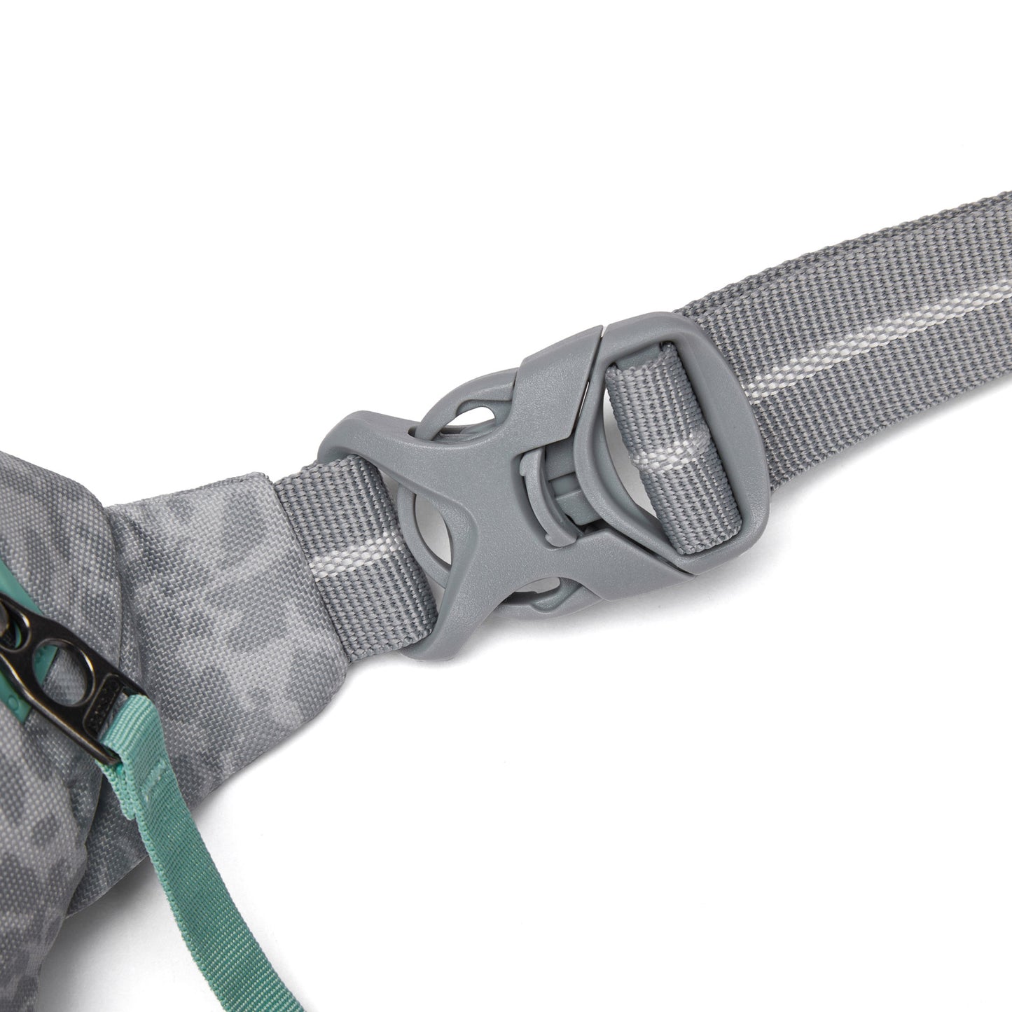 Close-up of Pacsafe® GO Anti-Theft Micro Sling gray buckle on strap, with teal zipper and fabric detail.