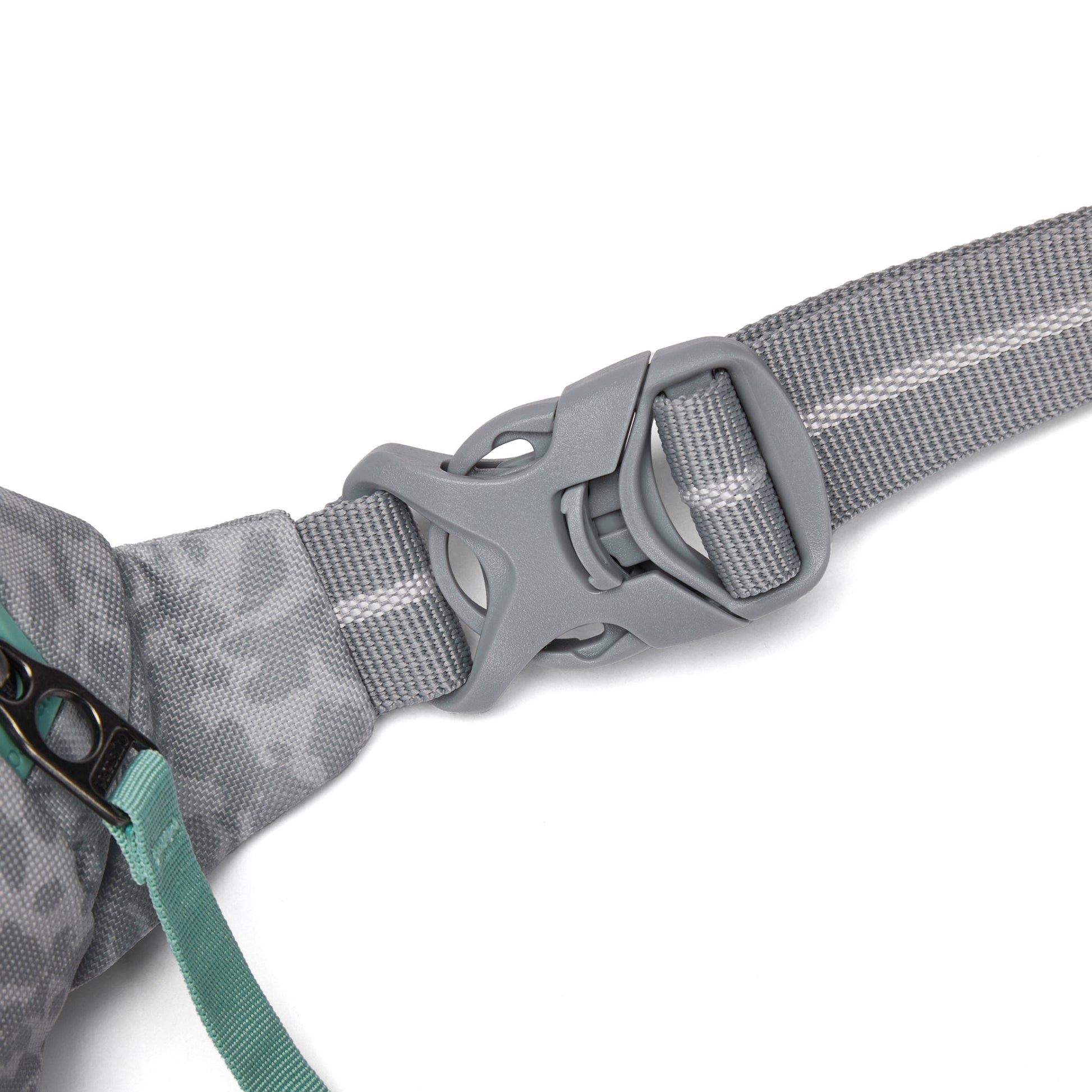 Close-up of Pacsafe® GO Anti-Theft Micro Sling gray buckle on strap, with teal zipper and fabric detail.