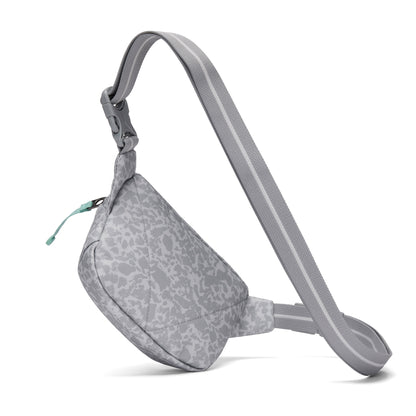Pacsafe® GO Anti-Theft Micro Sling crossbody bag in light gray with pattern, zipper, and adjustable strap.
