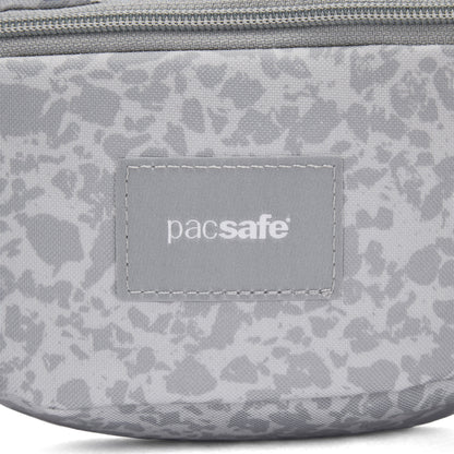 Close-up of the Pacsafe® GO Anti-Theft Micro Sling in gray with logo patch and top zipper.