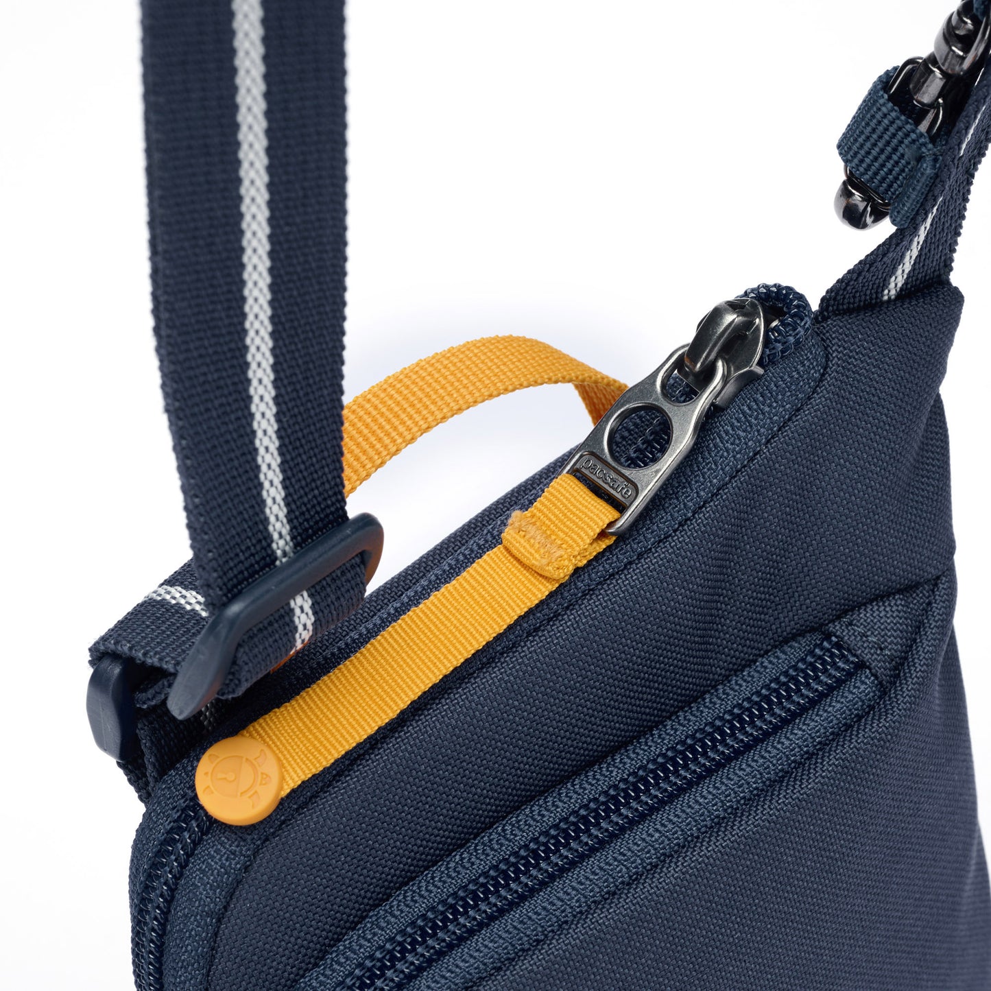 Close up of lockable zipper pull on coastal blue Pacsafe® GO Anti-Theft Tech Crossbody