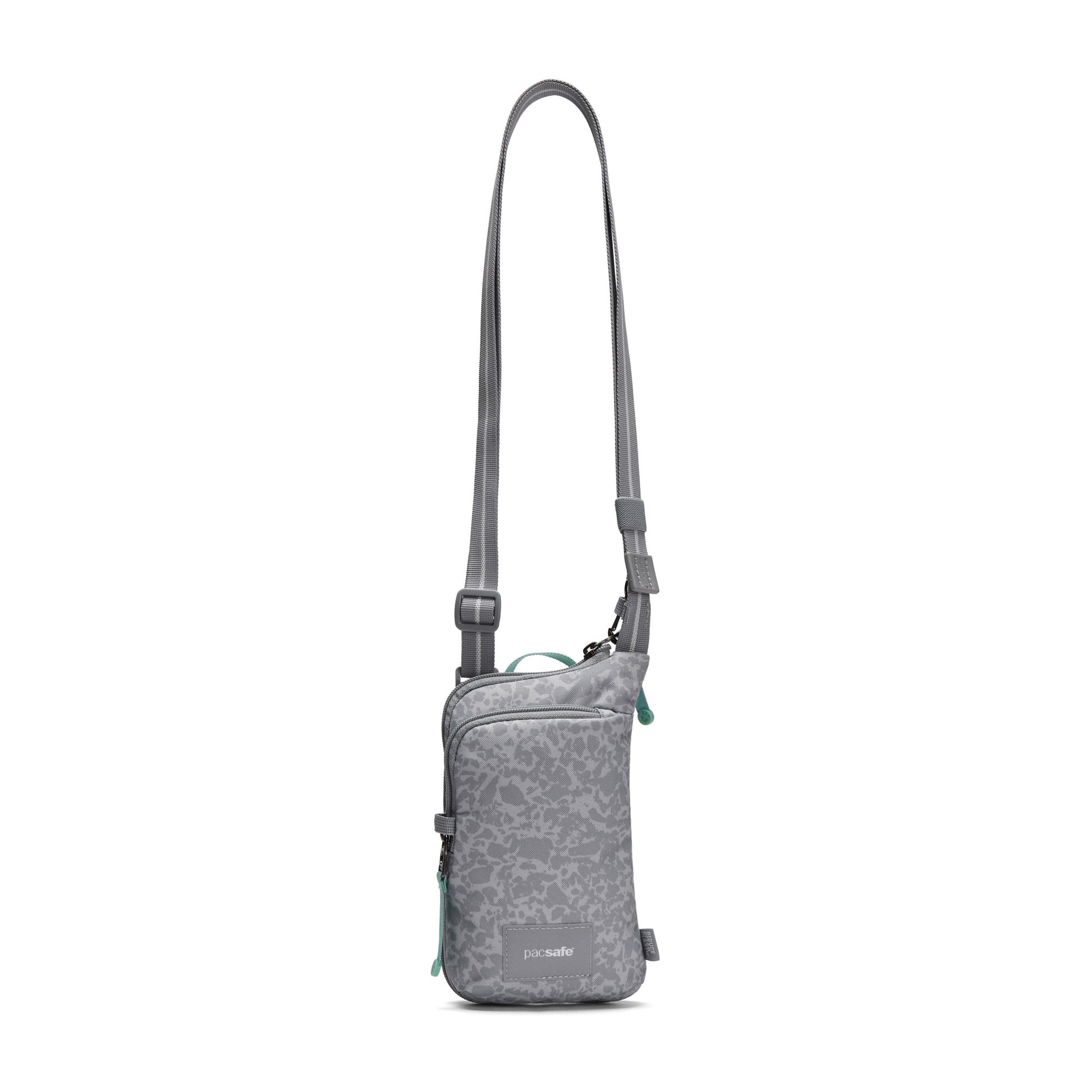 Pacsafe® GO Anti-Theft Tech Crossbody by Pacsafe: floral, adjustable strap, front zip pocket—perfect for travel.