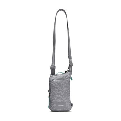 Pacsafe® GO Anti-Theft Tech Crossbody by Pacsafe: floral, adjustable strap, front zip pocket—perfect for travel.