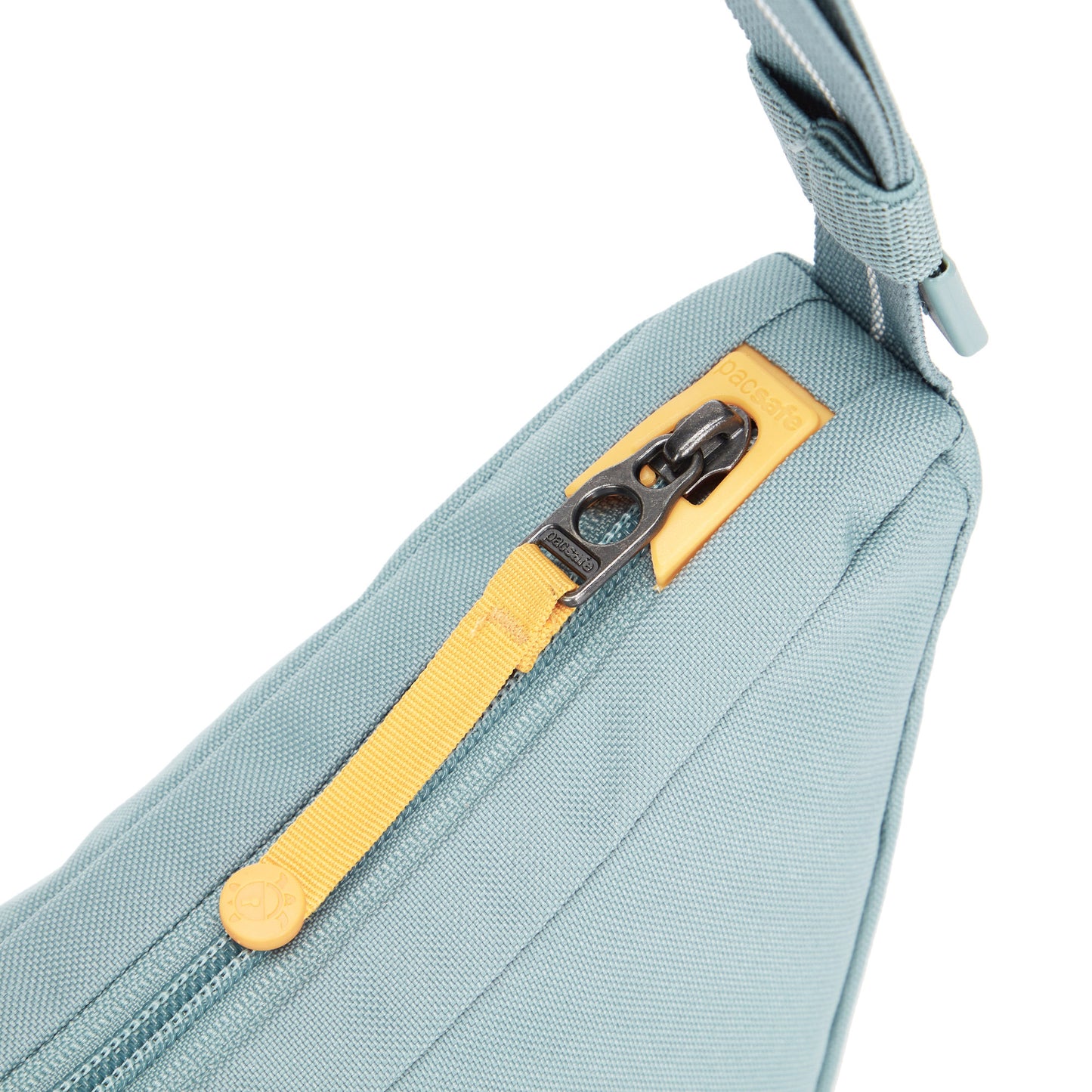 Close up of yellow zipper pull on fresh mint Pacsafe® GO Anti-Theft Lunar Crossbody