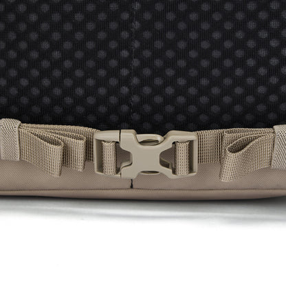 Close-up of a beige buckle on the Pacsafe® V 16L Anti-theft All-Around Backpack strap against black background.