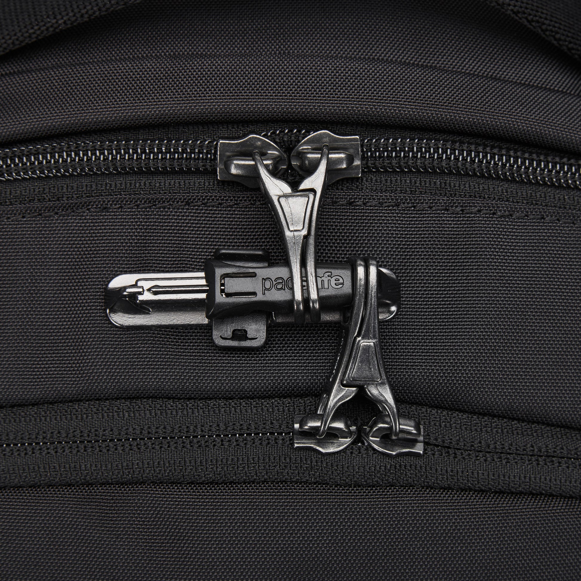 Close-up of dual black zippers on the Pacsafe® V 20L Anti-theft City Backpack made of recycled polyester.