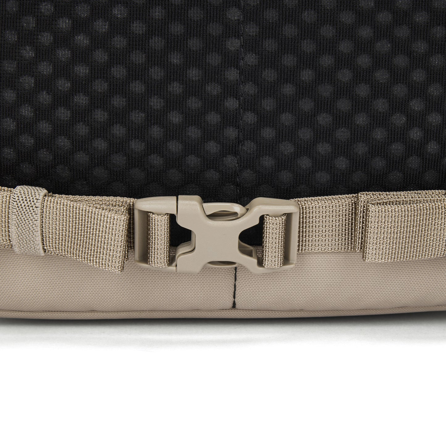 Close-up of a beige plastic buckle on the Pacsafe® V 20L Anti-theft City Backpack by Pacsafe.