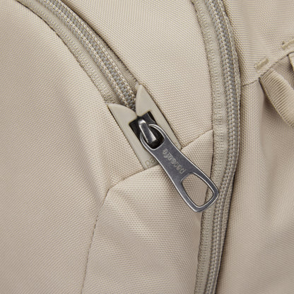 Close-up of Pacsafe® V 26L Anti-theft Tour Backpack in beige, made from recycled polyester with a metal zipper pull.