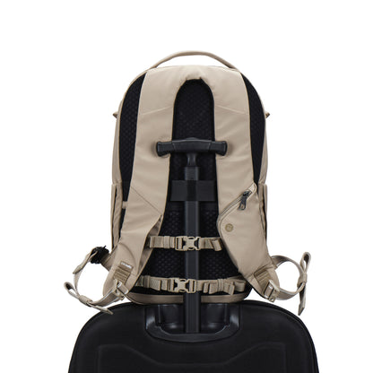 Pacsafe® V 26L Anti-theft Tour Backpack in beige on a black suitcase handle, shown from the back.