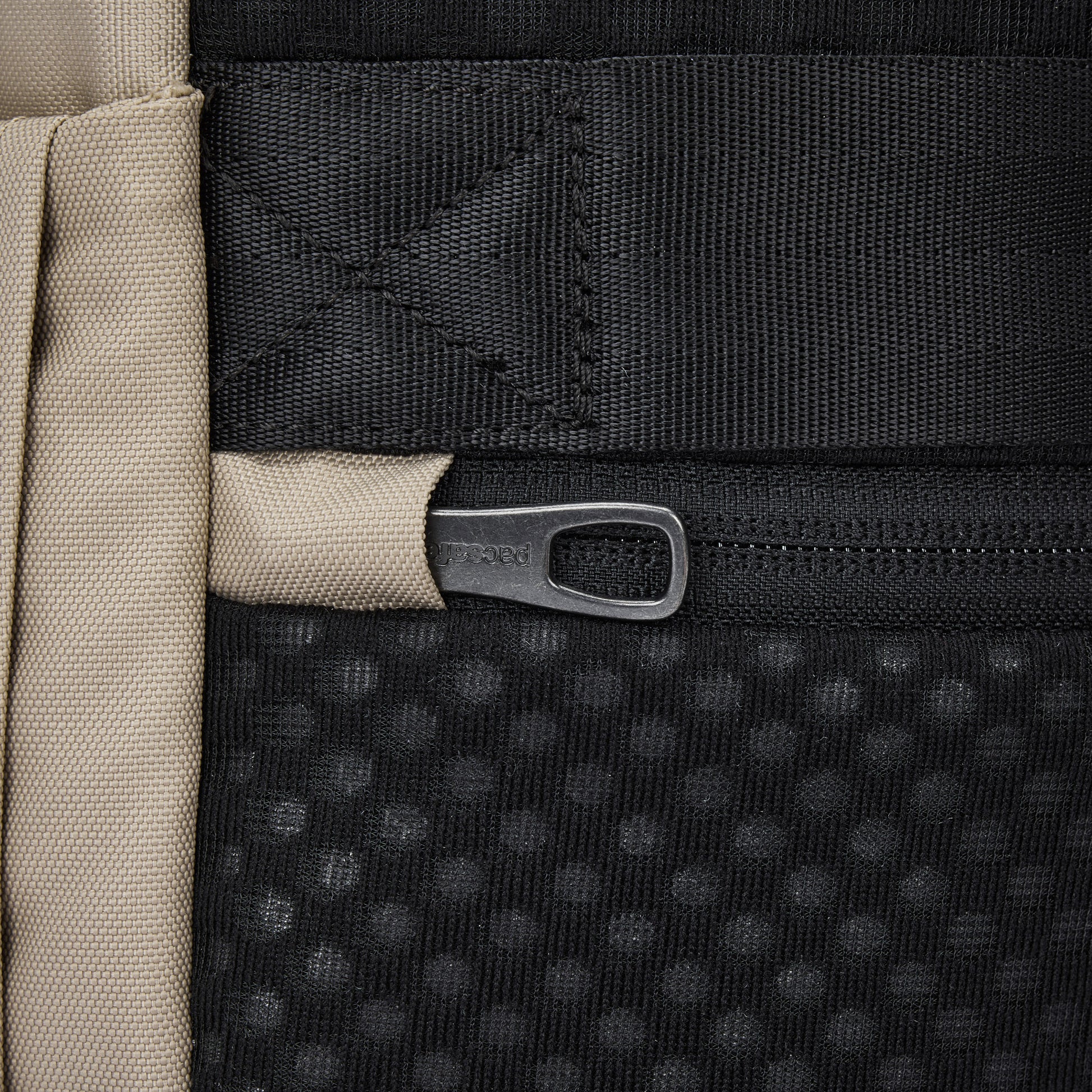 Close-up of the Pacsafe® V 26L Anti-theft Tour Backpack in black and beige with a dotted texture by Pacsafe.