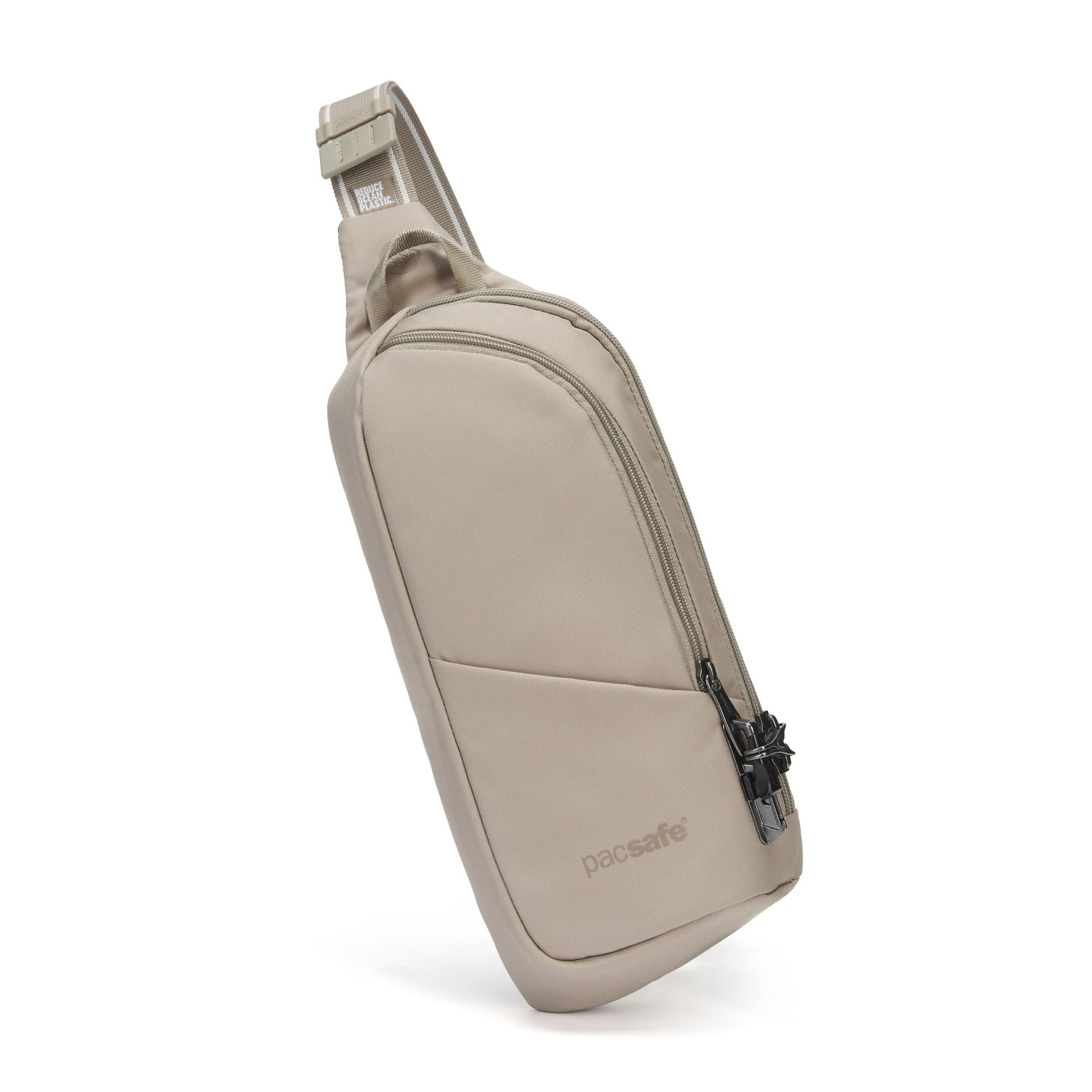 The Pacsafe® V Anti-theft Action Sling Pack in beige, with a front zipper pocket and adjustable strap, made from recycled polyester.