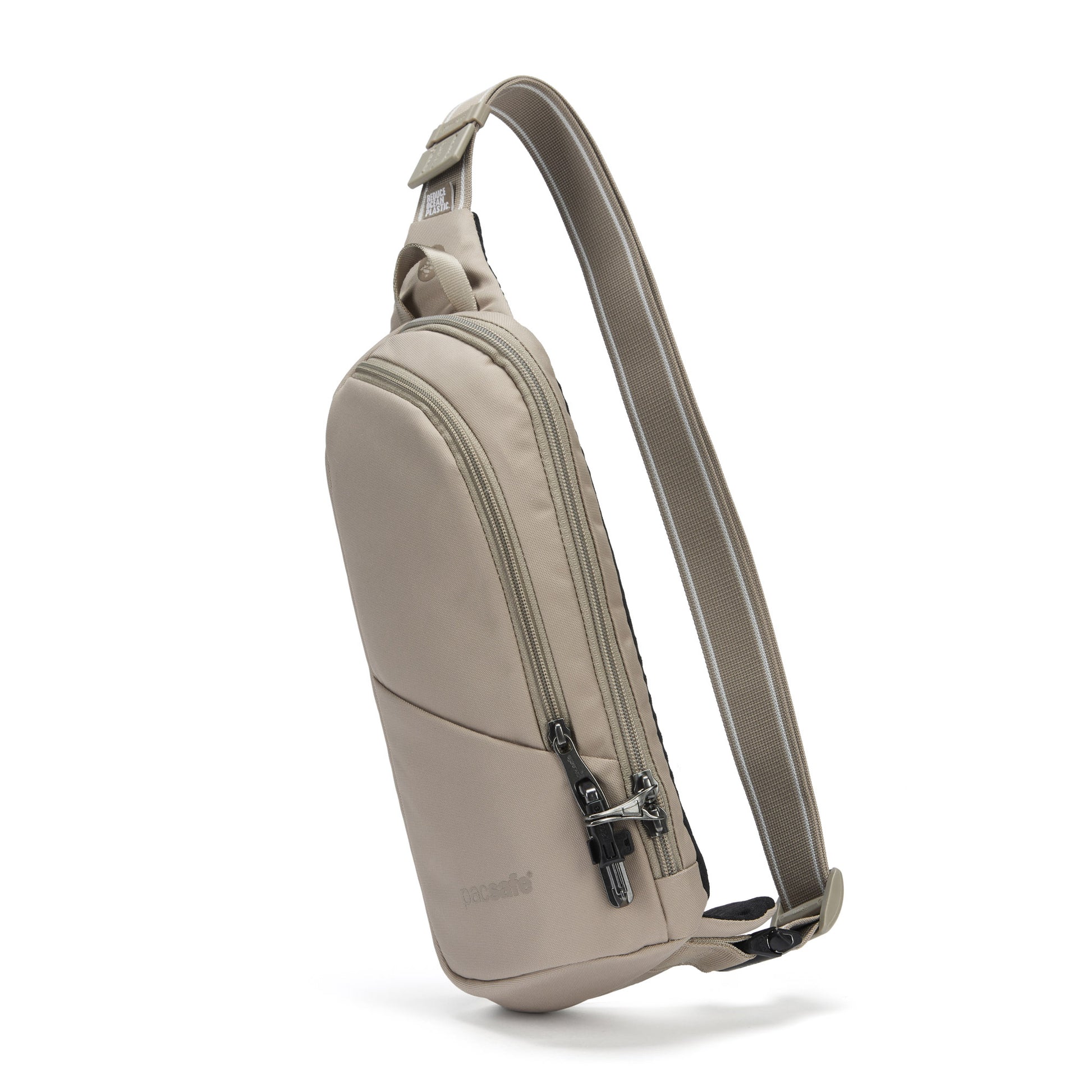 The Pacsafe® V Anti-theft Action Sling Pack in beige, with a front zipper pocket and adjustable strap, made from recycled polyester, front angled view.