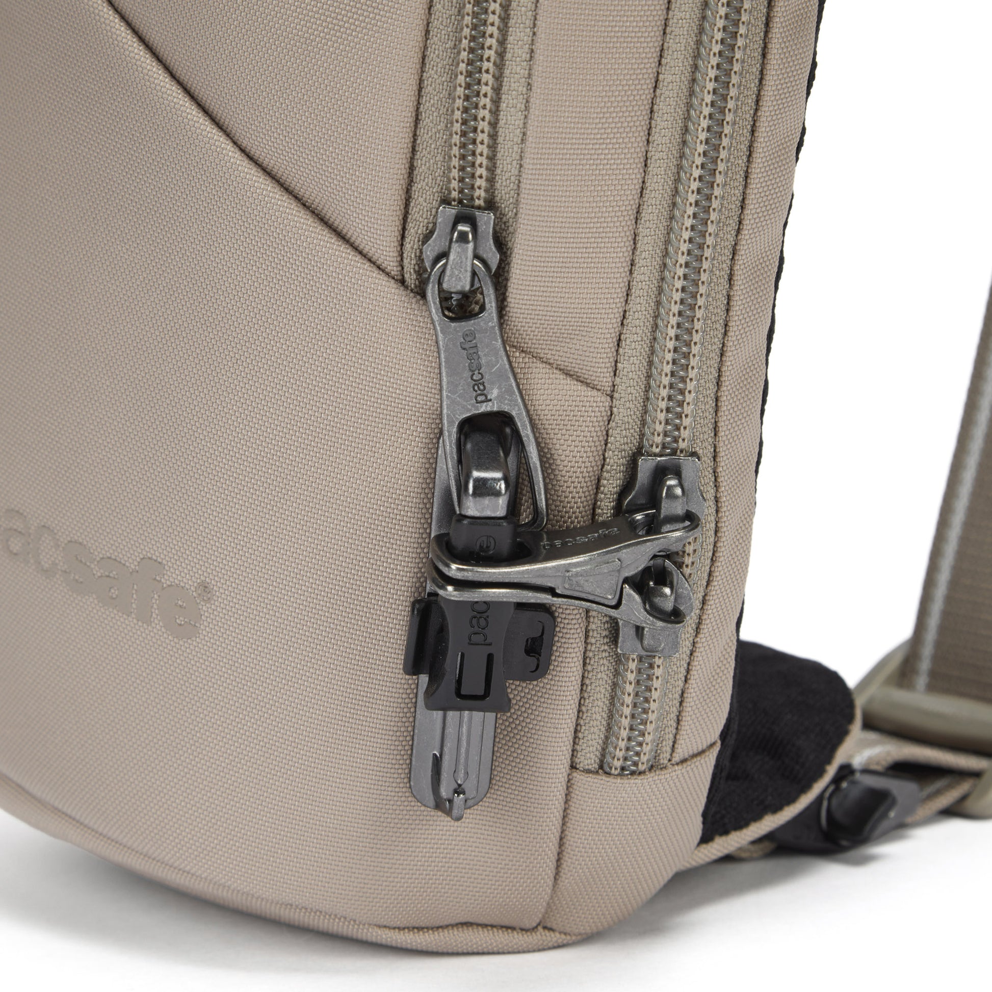 Close up of lockable zippers on beige Action Sling.