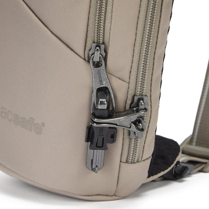 Close up of lockable zippers on beige Action Sling.