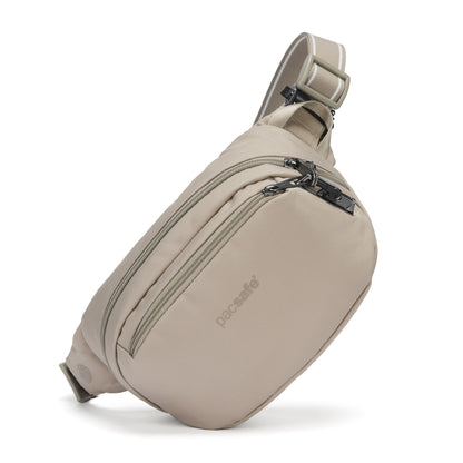 Pacsafe® V anti-theft hip pack in beige  with front zipper, and logo, made from recycled polyester.