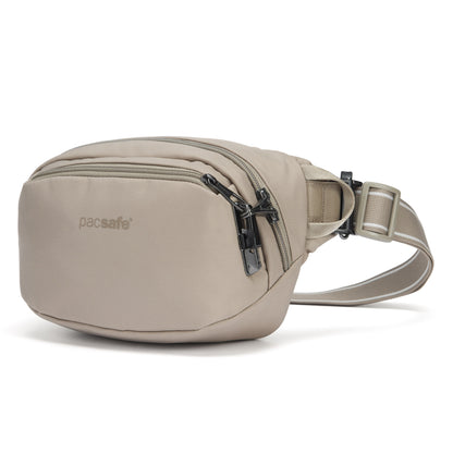 Pacsafe® V anti-theft hip pack in beige, with locked zippers, front angled view.