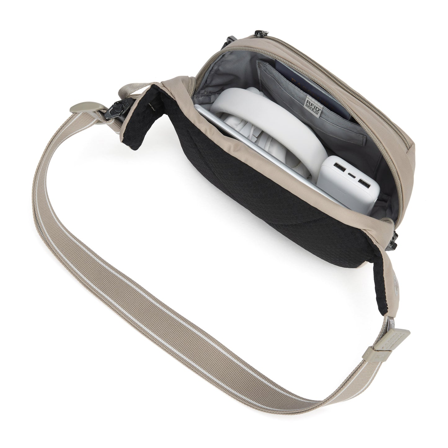 Pacsafe® V anti-theft hip pack in beige, top view with headphones and charger inside.
