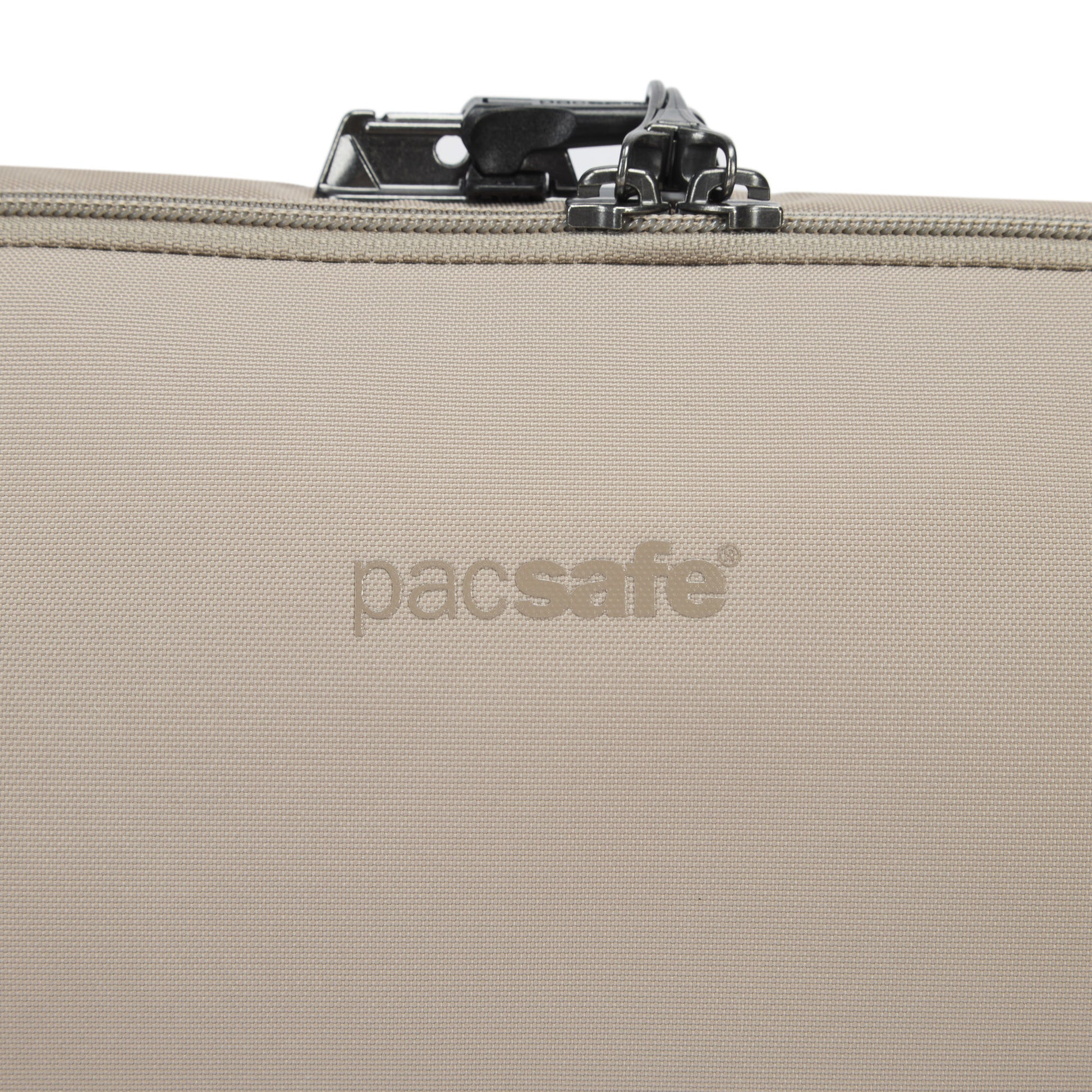 Close-up of Pacsafe® V Anti-theft Urban Sling in beige, showing top zipper and lock.