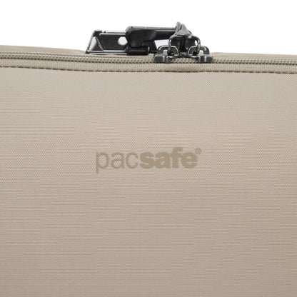 Close-up of Pacsafe® V Anti-theft Urban Sling in beige, showing top zipper and lock.