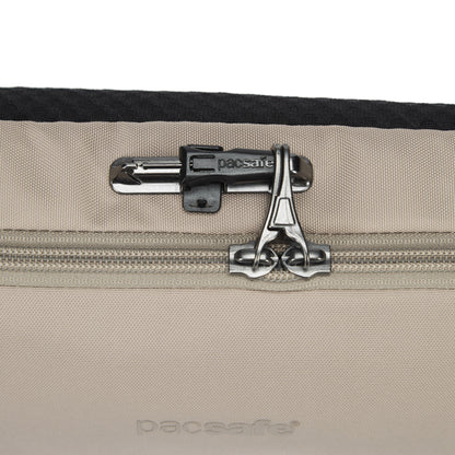 Close-up of the Pacsafe® V Anti-theft Urban Sling in beige, featuring dual zippers with a built-in lock.