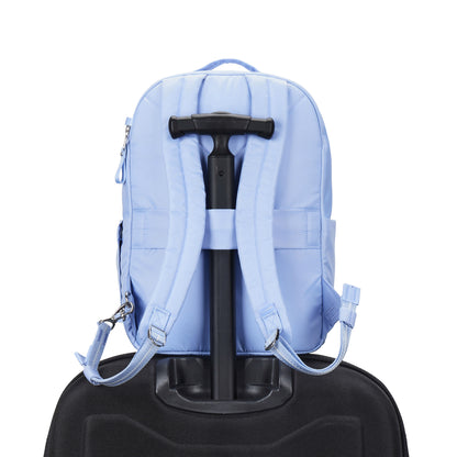 Pacsafe® W 10L Anti-theft Backpack in serenity blue on a handle of luggage.