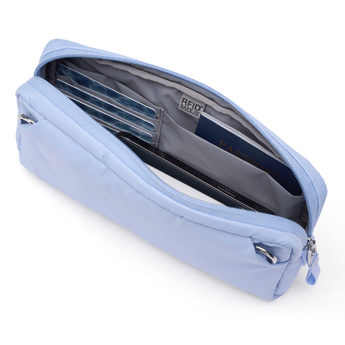 Light blue Pacsafe® W Anti-theft 3-in-1 Sling open to show card slots, passport, and RFID safe label inside.
