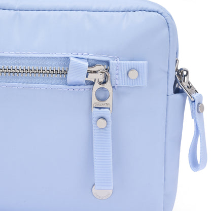 Close-up of the Pacsafe® W Anti-theft 3-in-1 Sling in light blue with silver zipper and matching pull tab.
