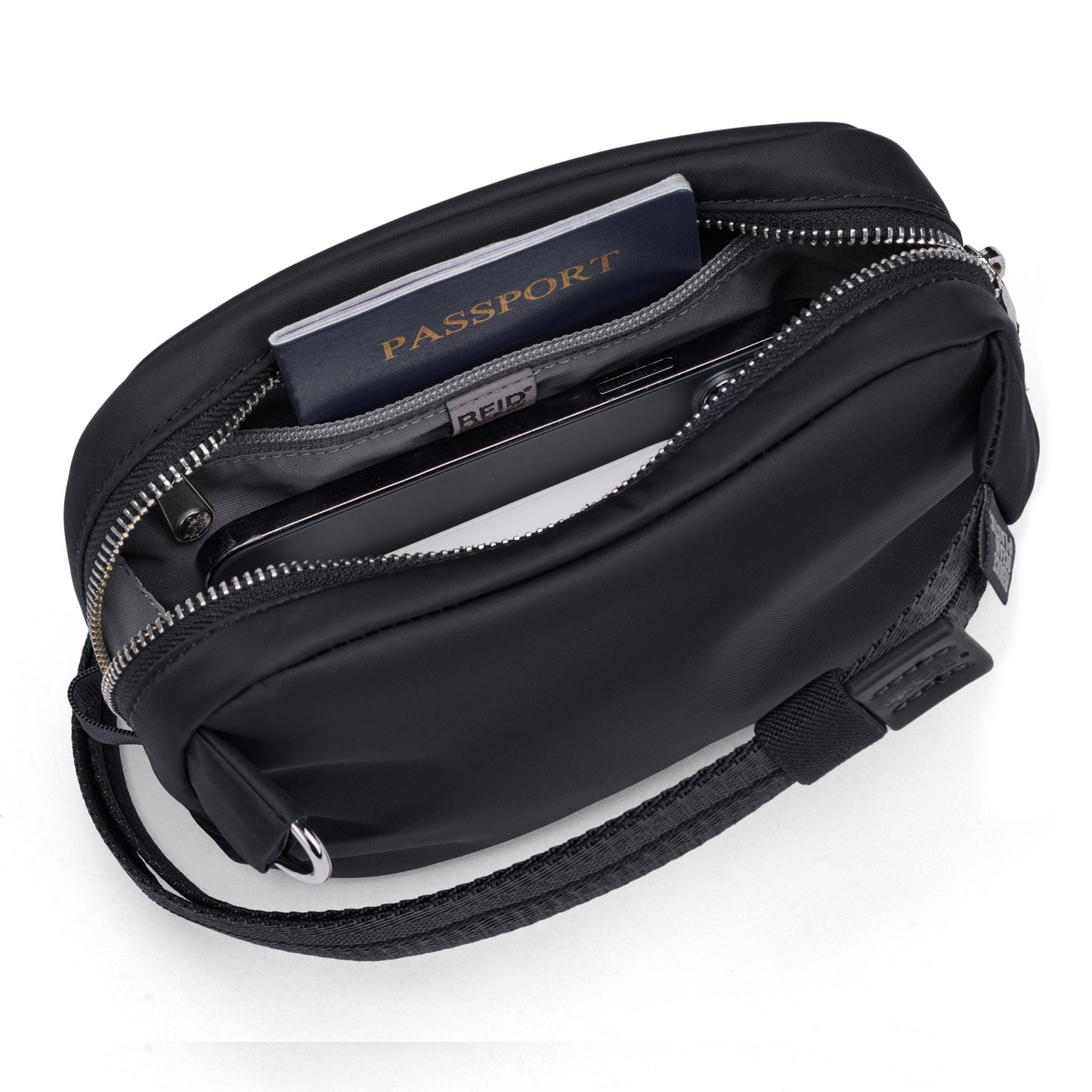 Pacsafe® W Anti-theft Micro Sling partially open, revealing passport and phone in RFID-blocking pockets.