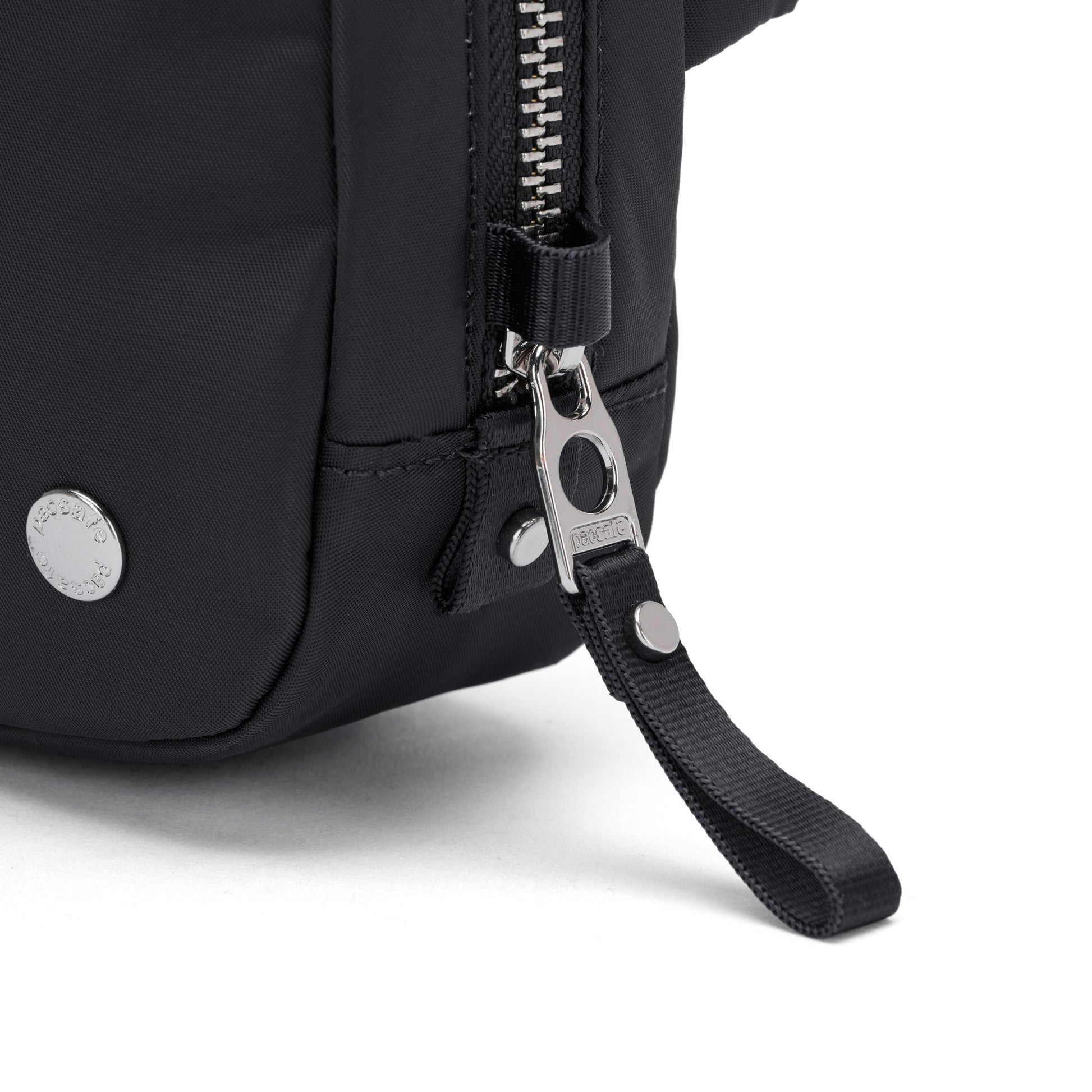 Close-up of Pacsafe® W Anti-theft Micro Sling’s metal zipper and pull tab, made from recycled polyester.
