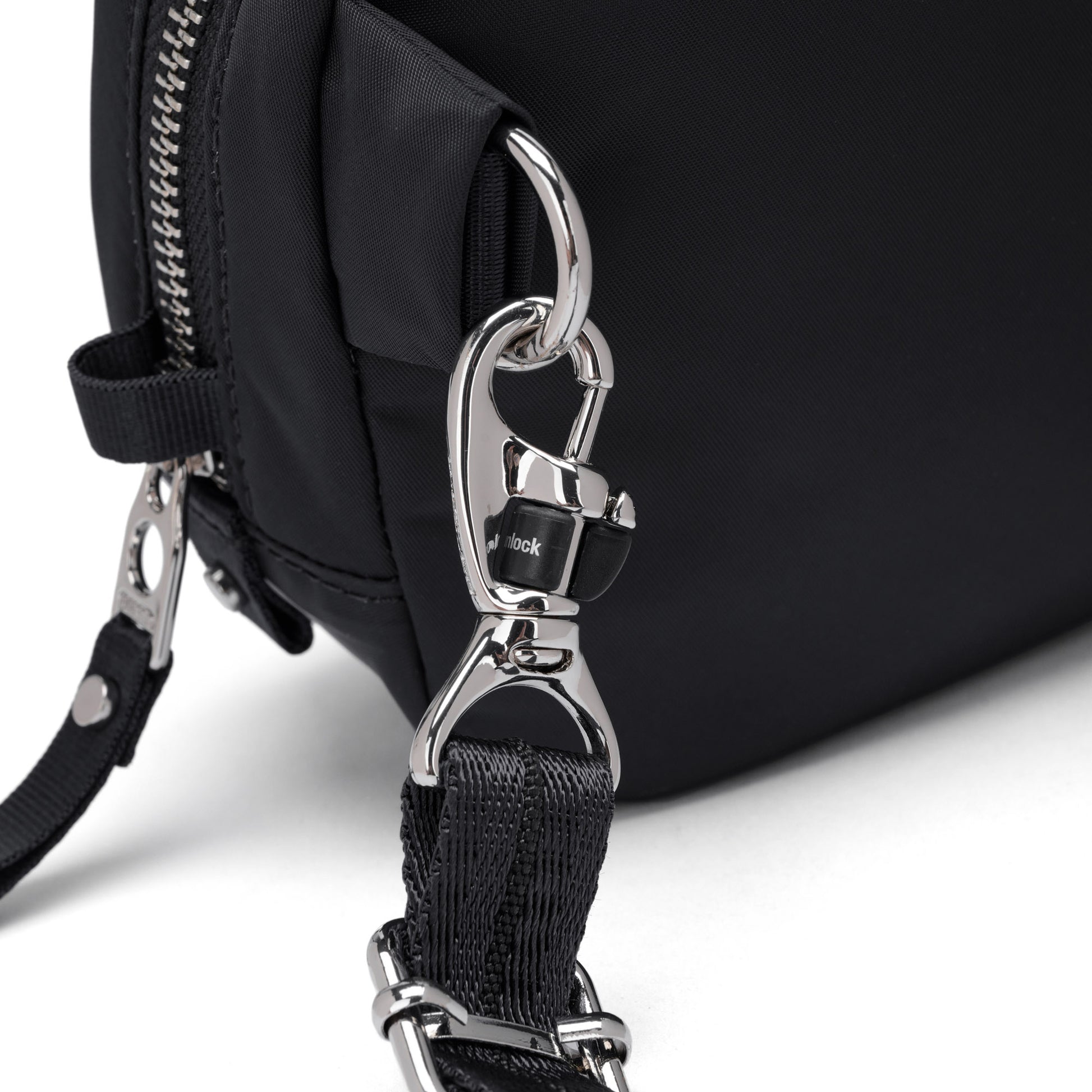 Close-up of the Pacsafe® W Anti-theft Micro Sling with detachable strap, silver clip, and recycled polyester.