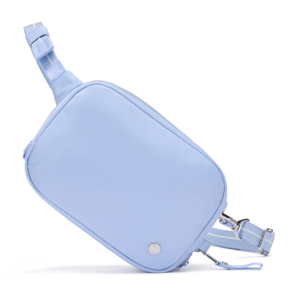 Pacsafe® W Anti-theft Micro Sling by Pacsafe with RFID blocking, zipper closure, and adjustable strap in light blue.
