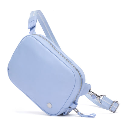 Pacsafe® W Anti-theft Micro Sling: light blue recycled polyester bag with zipper, adjustable strap, metallic logo.