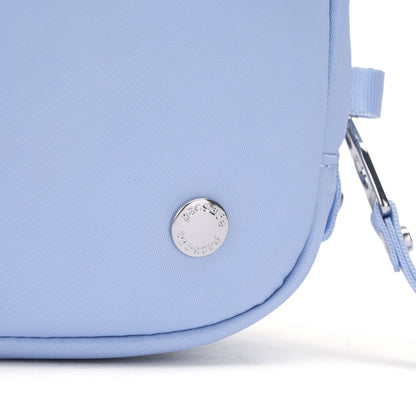 Close-up of the Pacsafe® W Anti-theft Micro Sling in light blue with a round silver logo and matching strap.