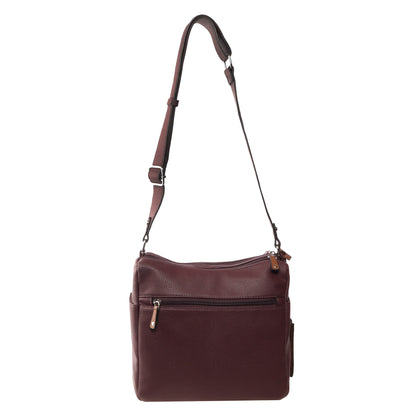 Seven Days Bloodwood Vegan Leather Crossbody with adjustable strap and front zip pocket, shown on white.