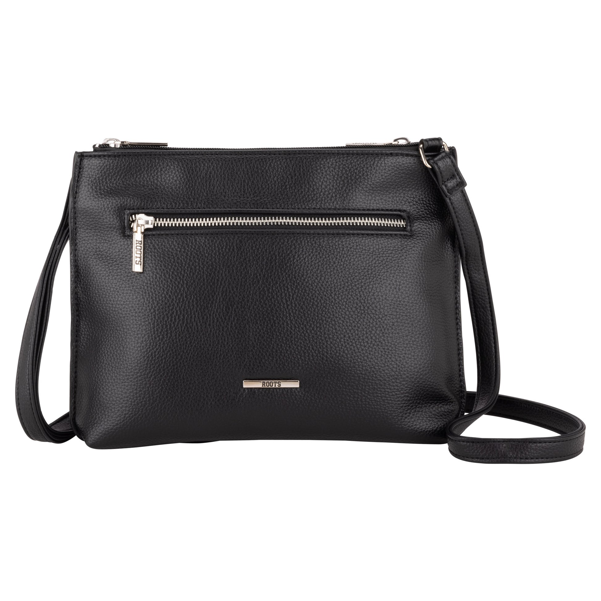 Roots 3-Compartment Crossbody by Roots—black leather with front zip pocket, adjustable strap, white background.