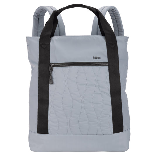 Product Image – Roots Kammy Wavy Quilted Tote Backpack in blue, with black straps and front zipper pocket.