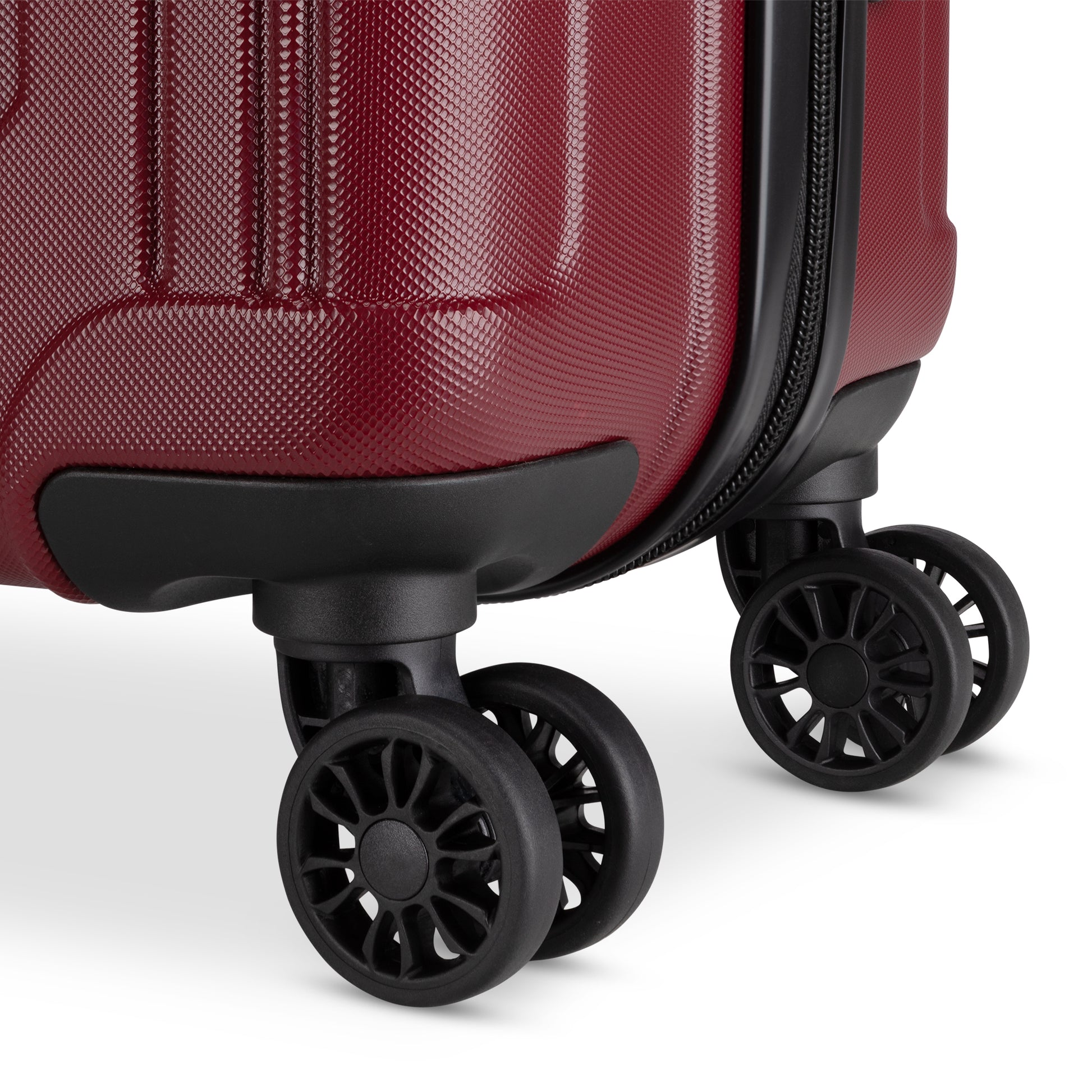 Close up of black spinner wheels on merlot Roots Identity 19" Hardside Spinner Carry-on