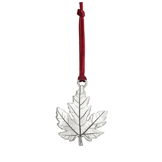 Product Image – Seagull Pewter Maple Leaf Ornament hanging from a red ribbon.