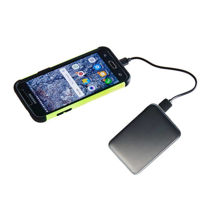 A smartphone connected to the High Road Power Bank by High Road with a charging cable on a white background.