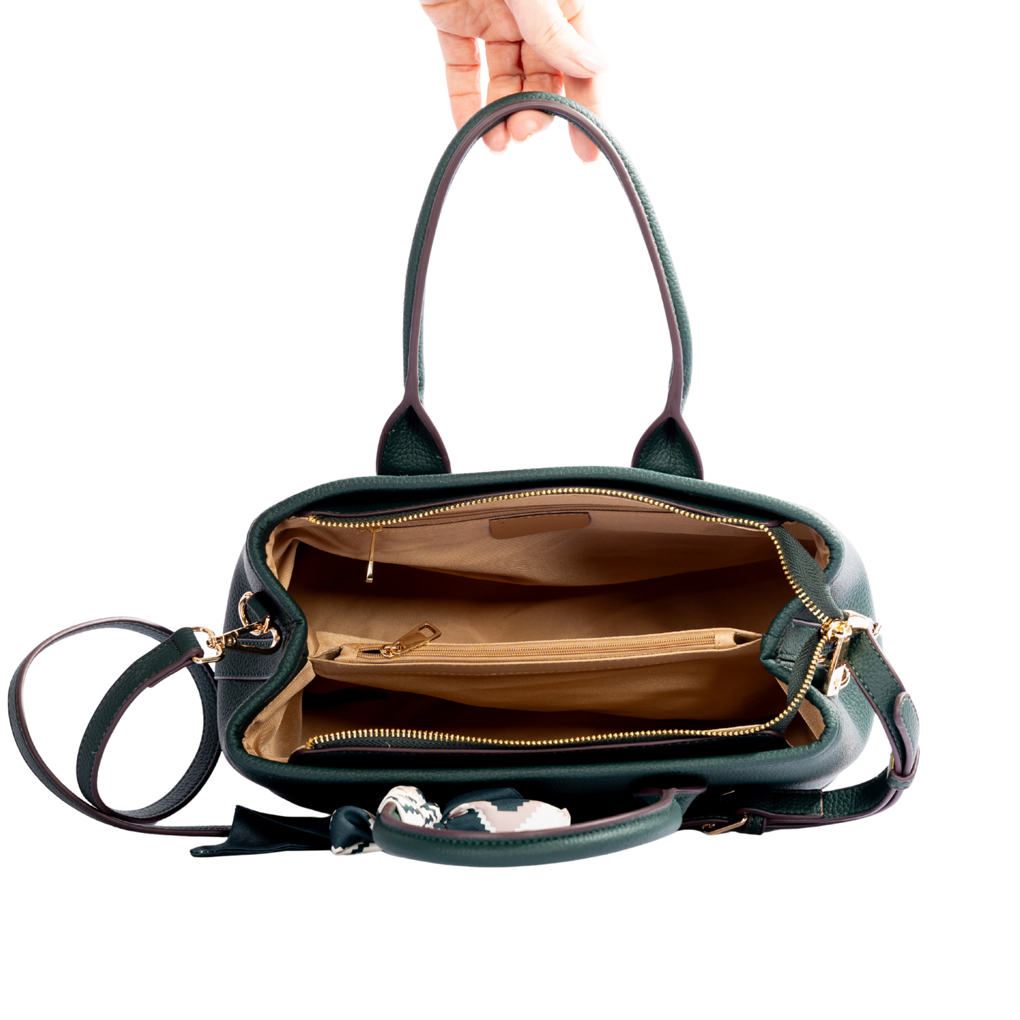 Hand holding open the Miss Caprice Solana Handbag, showing zippered and open pockets in the tan interior.