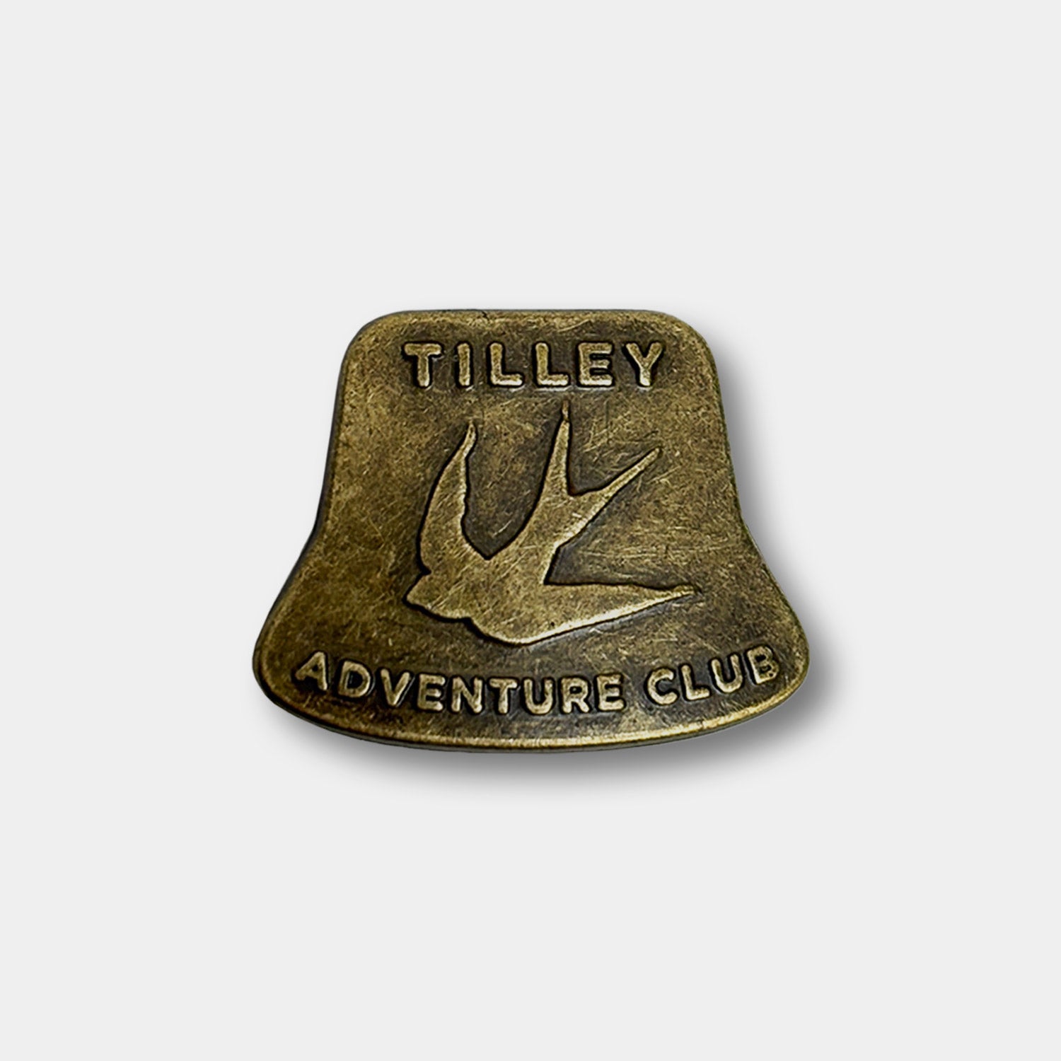 Tilley Adventure Club Hat Pin: Brass bucket hat-shaped pin with bird and "Tilley Adventure Club" engraving.