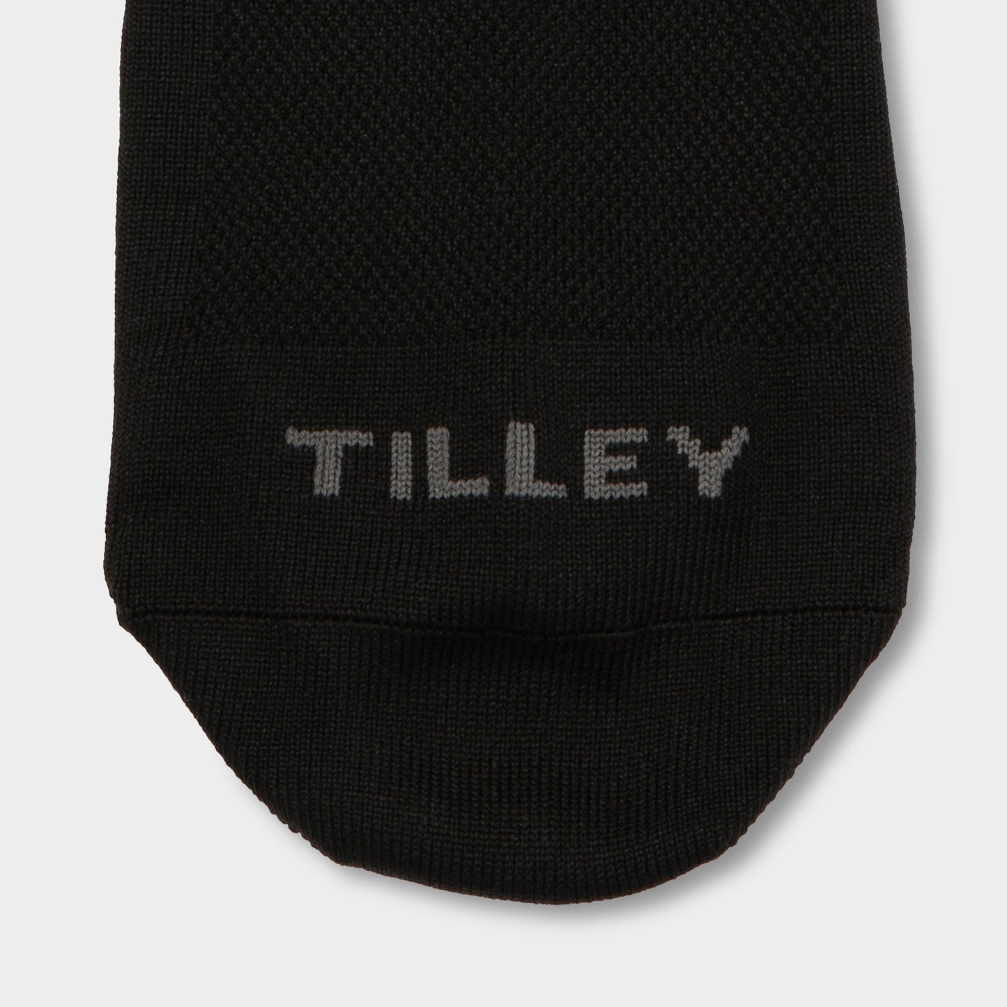 Close-up of the toe area of a Tilley Mid Calf Travel Sock, featuring “TILLEY” stitched in gray.