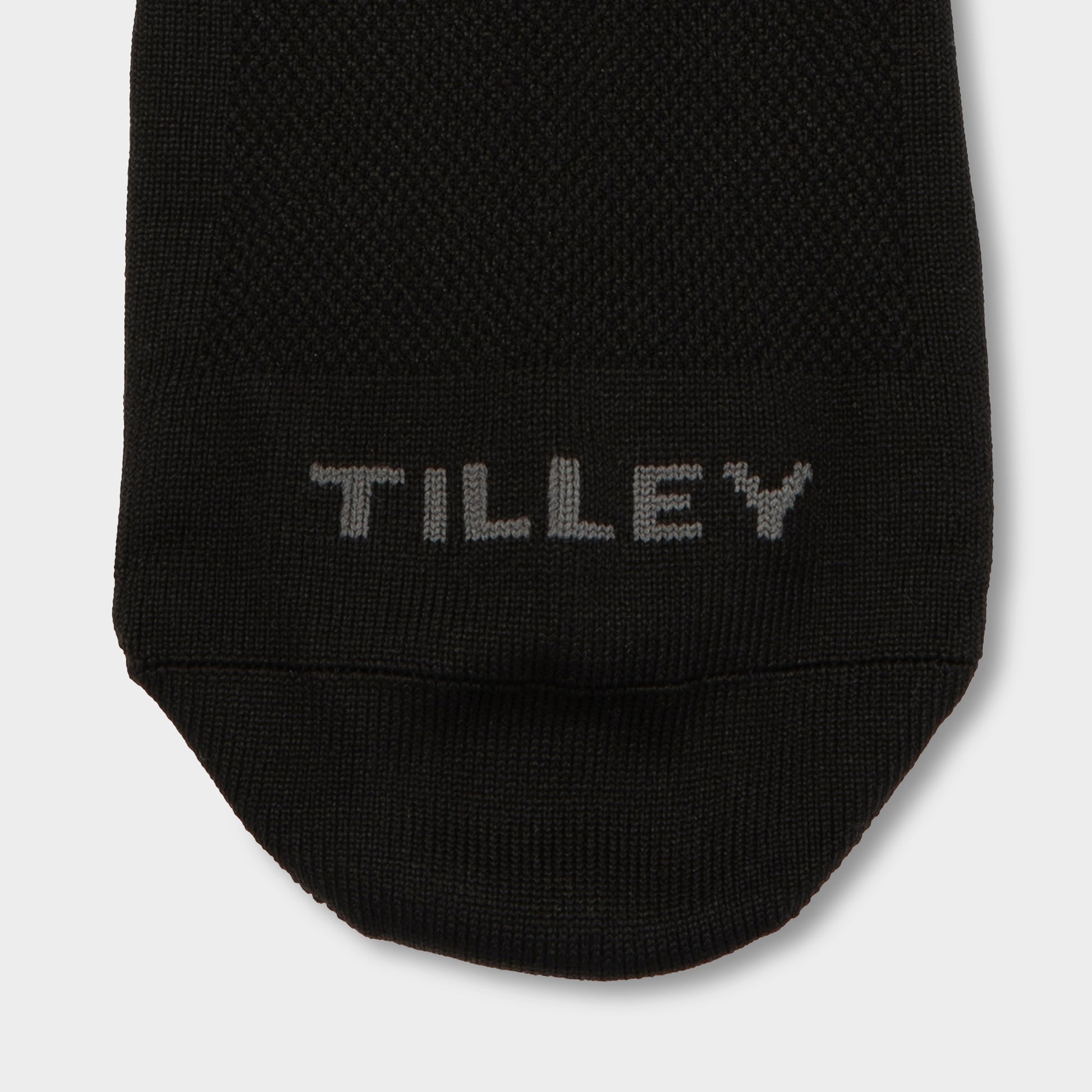 Close-up of the toe area of a Tilley Mid Calf Travel Sock, featuring “TILLEY” stitched in gray.