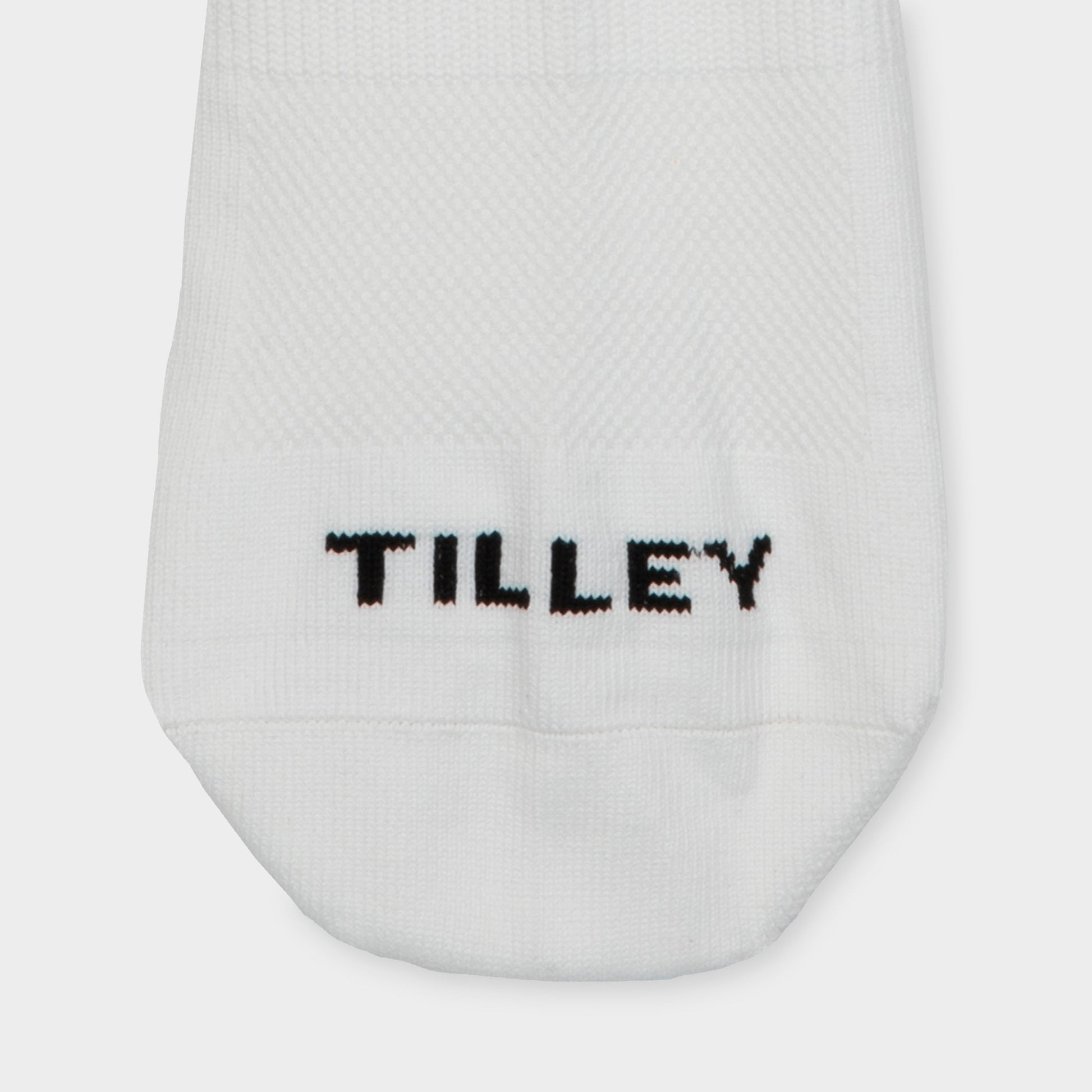 Tilley Mid Calf Travel Sock in white with "TILLEY" embroidery and arch support. Online only.