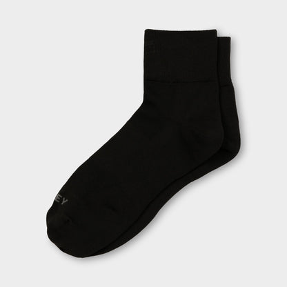 A pair of Tilley Ankle Travel Socks in black with arch support, side by side on a white background.
