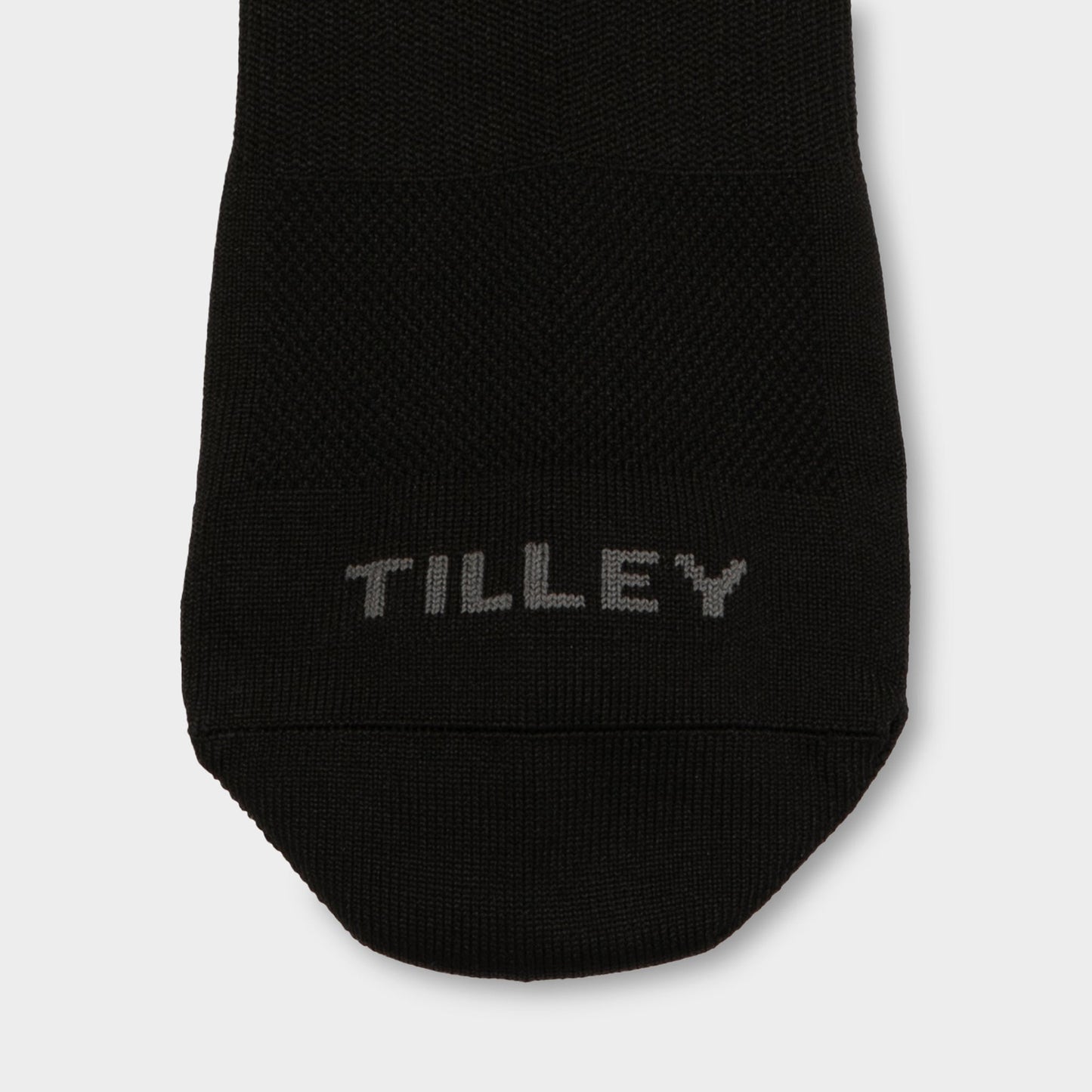 Close-up of the Tilley Ankle Travel Sock - ONLINE ONLY, showing "TILLEY" in gray on the black toe.